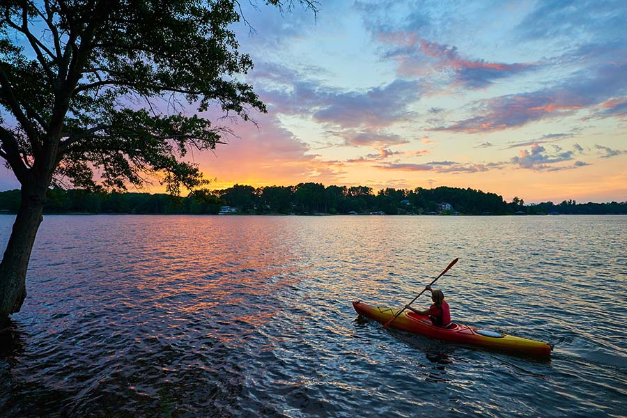 Life And Health - Woman Kayaking Out On Lake At Sunset